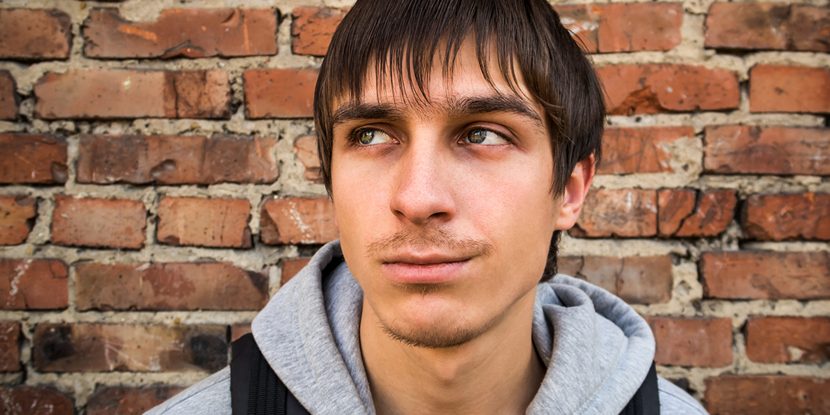 A serious young man outdoors