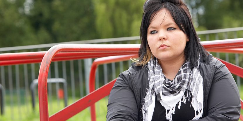 Young Woman Sitting In Playground