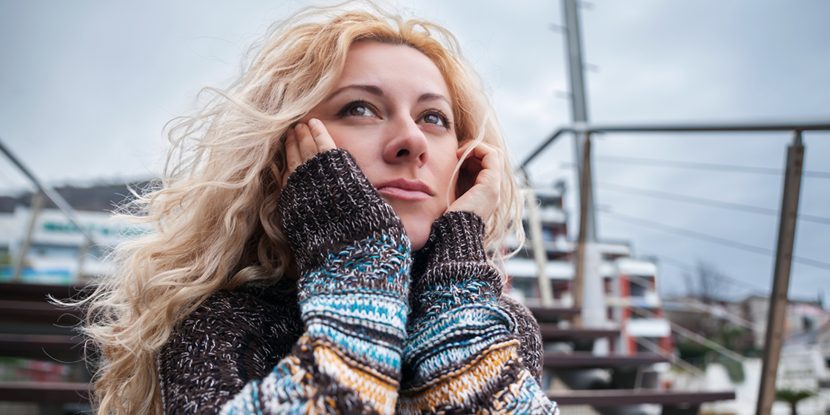 A serious young woman standing outdoors